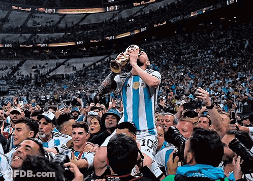 A Soccer Player With The Number 10 On His Shorts Holds A Trophy In His Mouth GIF