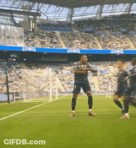 A Soccer Player With The Number 10 On His Shorts Is Dancing On The Field GIF