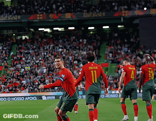 A Soccer Player With The Number 11 On His Back Is Celebrating With His Teammates GIF