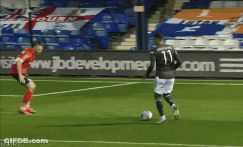 A Soccer Player With The Number 11 On His Jersey Is Kicking The Ball GIF