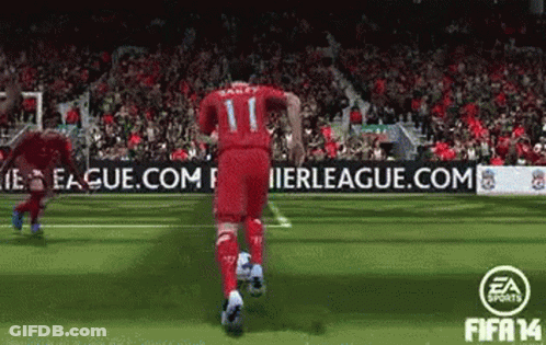 A Soccer Player With The Number 11 On His Jersey Is Running With A Soccer Ball GIF