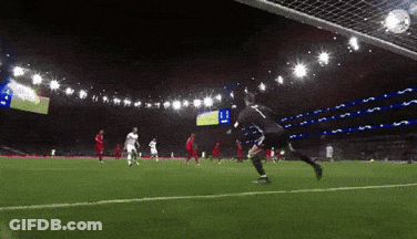 A Soccer Player With The Number 11 On His Jersey Kicks The Ball Into The Net GIF