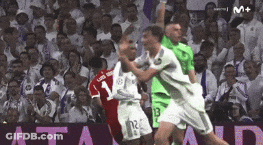 A Soccer Player With The Number 12 On His Shorts Is Being Tackled By Another Player GIF