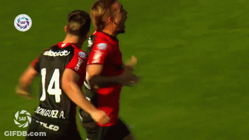 A Soccer Player With The Number 14 On His Back Is Hugging Another Player GIF