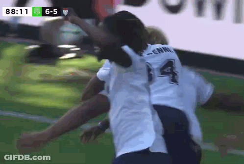 A Soccer Player With The Number 14 On His Back Is Hugging Another Player GIF