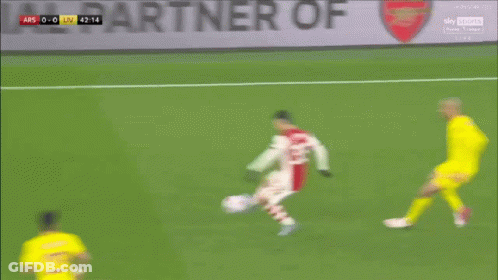 A Soccer Player With The Number 14 On His Jersey Is Dribbling The Ball GIF
