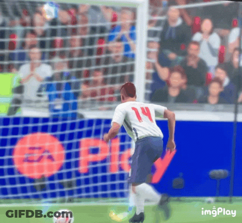 A Soccer Player With The Number 14 On His Jersey Is Kicking The Ball GIF