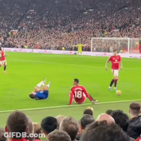 A Soccer Player With The Number 18 On His Jersey Is Sitting On The Ground GIF
