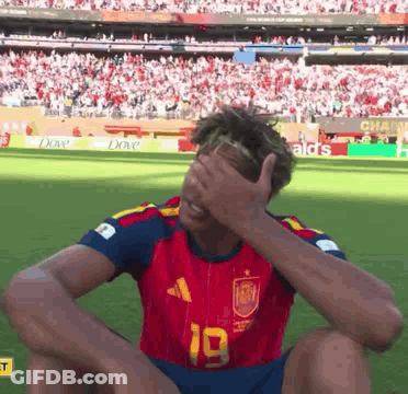A Soccer Player With The Number 19 On His Jersey Covering His Face GIF