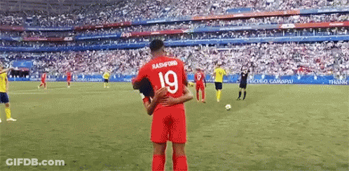 A Soccer Player With The Number 19 On His Jersey Is Hugging Another Soccer Player . GIF