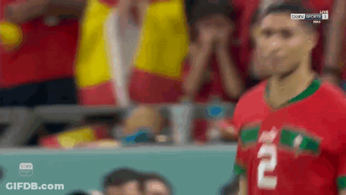 A Soccer Player With The Number 2 On His Jersey Stands In Front Of A Crowd . GIF