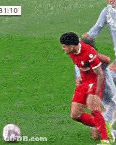 A Soccer Player With The Number 2 On His Shorts Is Trying To Tackle Another Player GIF