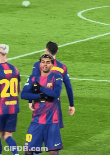 A Soccer Player With The Number 20 On His Jersey Is Hugging Another Player GIF