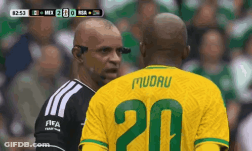 A Soccer Player With The Number 20 On His Jersey Talks To A Referee GIF