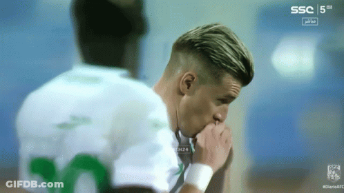 A Soccer Player With The Number 20 On His Shirt Looks Down GIF