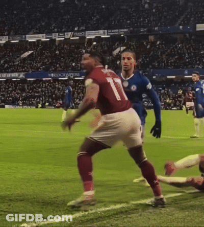 A Soccer Player With The Number 20 On His Shorts Is Being Tackled By Another Player GIF