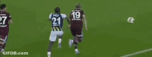 A Soccer Player With The Number 21 On His Jersey Kicks The Ball GIF