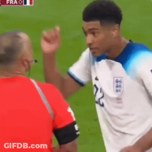 A Soccer Player With The Number 22 On His Jersey Is Talking To A Referee On The Field . GIF