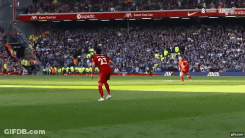 A Soccer Player With The Number 23 On His Jersey Is Kicking The Ball GIF