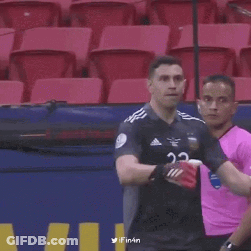 A Soccer Player With The Number 23 On His Jersey Is Standing In A Stadium . GIF