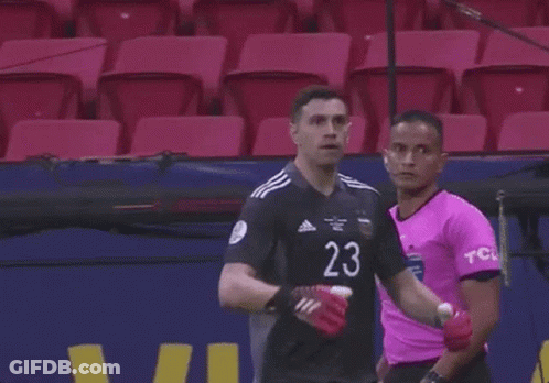 A Soccer Player With The Number 23 On His Jersey Is Standing In Front Of A Microphone . GIF