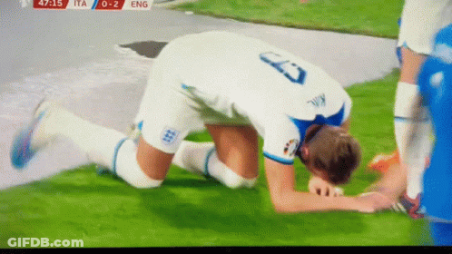 A Soccer Player With The Number 23 On His Jersey Kneeling On The Field GIF
