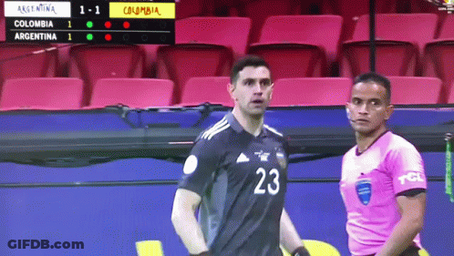 A Soccer Player With The Number 23 On His Jersey Stands Next To A Referee GIF