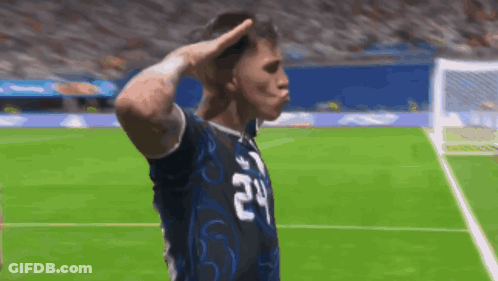 A Soccer Player With The Number 24 On His Jersey Salutes The Crowd GIF