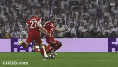A Soccer Player With The Number 27 On His Jersey Kicking The Ball GIF