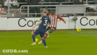 A Soccer Player With The Number 3 On His Jersey Is Kicking A Soccer Ball GIF