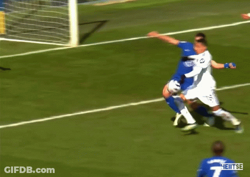 A Soccer Player With The Number 4 On His Jersey Is Surrounded By Other Players GIF