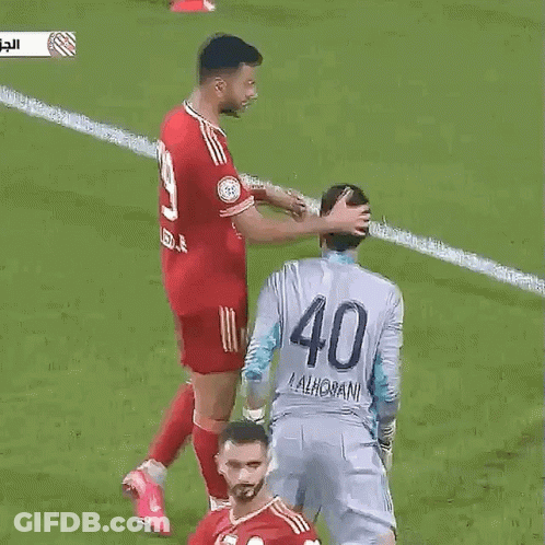 A Soccer Player With The Number 40 On His Back Is Being Touched By Another Player . GIF