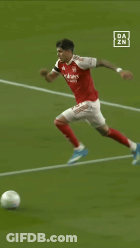 A Soccer Player With The Number 5 On His Back Is Kicking The Ball GIF