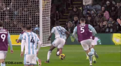 A Soccer Player With The Number 5 On His Jersey Kicks The Ball GIF