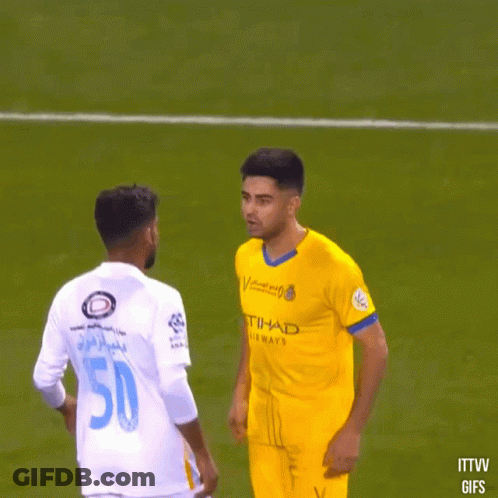 A Soccer Player With The Number 50 On His Back Talks To Another Player GIF