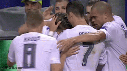 A Soccer Player With The Number 7 On His Back Is Hugged By His Teammates GIF
