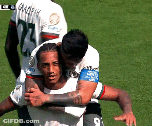 A Soccer Player With The Number 8 On His Armband Is Hugging Another Player GIF