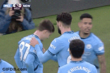 A Soccer Player With The Number 87 On His Jersey Hugs Another Player GIF