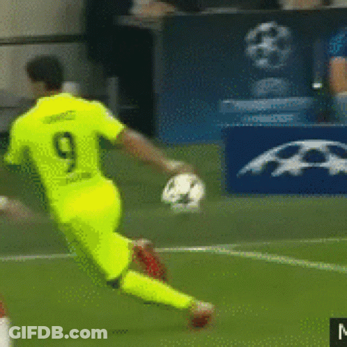 A Soccer Player With The Number 9 On His Jersey Is Kicking A Ball GIF