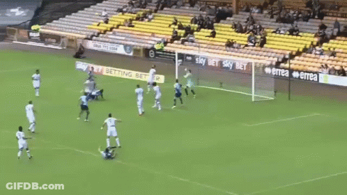 A Soccer Player With The Number 9 On His Jersey Is Laying On The Ground Surrounded By Other Players . GIF