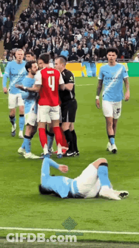 A Soccer Player With The Number 9 On His Jersey Is Laying On The Ground GIF