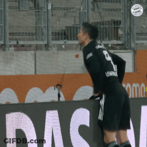 A Soccer Player With The Number 9 On His Jersey Leans Over A Wall GIF