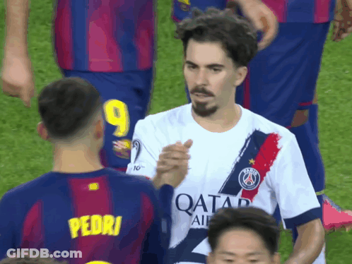 A Soccer Player With The Number 9 On His Jersey Shakes Hands With Another Player GIF