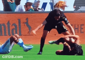 A Soccer Player With The Number 9 On His Shorts Is Being Tackled By Another Player GIF