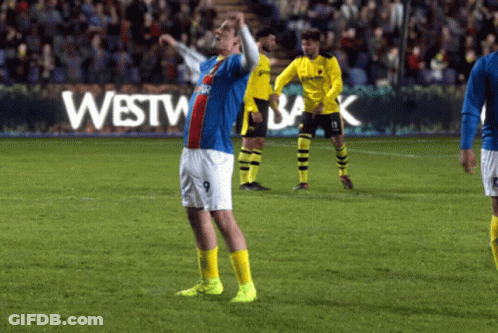 A Soccer Player With The Number 9 On His Shorts Stands On A Field GIF