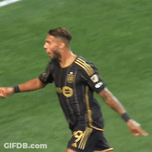 A Soccer Player With The Number 99 On His Jersey Is Squatting On The Field GIF
