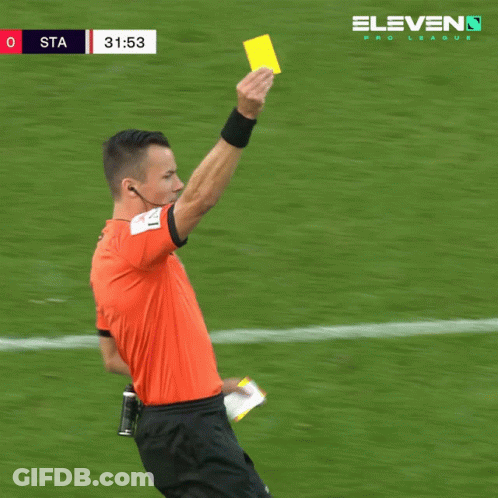 A Soccer Referee Holds Up A Yellow Card In Front Of A Eleven Pro League Banner GIF