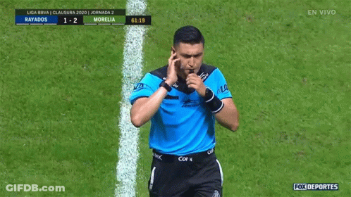 A Soccer Referee Is Pointing At A Scoreboard That Says Rayados 1-2 Morelia GIF