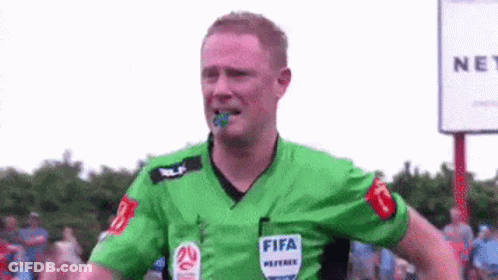 A Soccer Referee Wearing A Green Shirt With The Word Fifa On It GIF