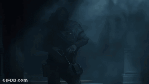 A Soldier In A Dark Room With A Mask On His Face GIF